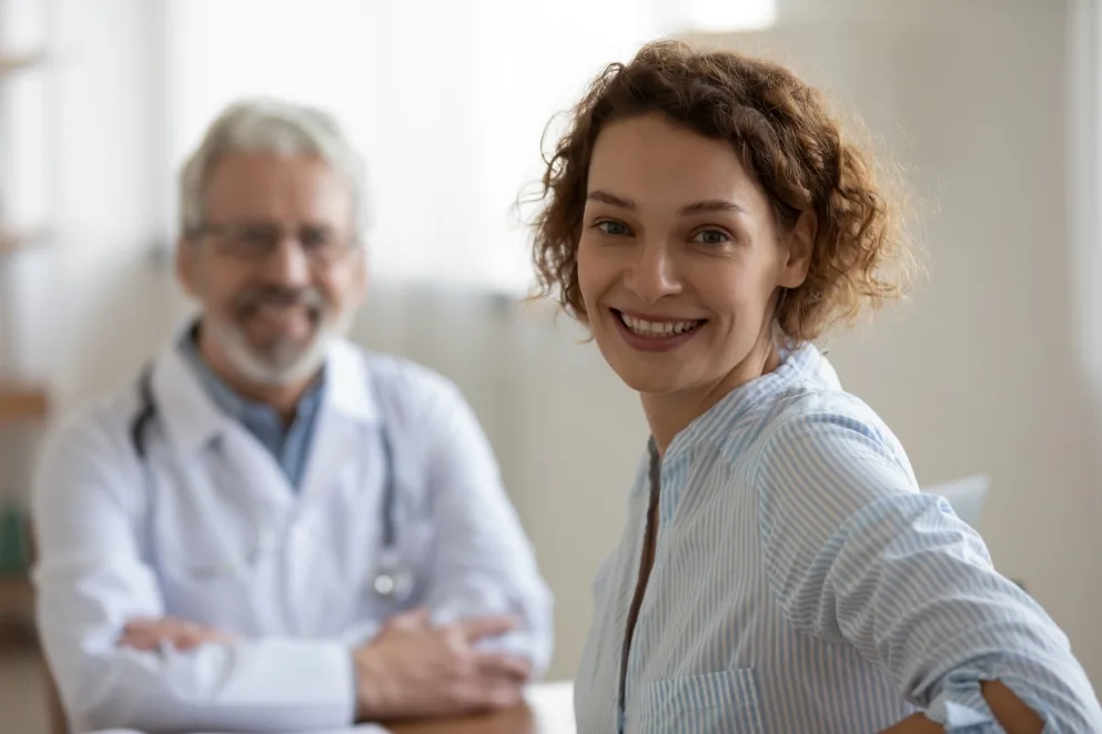 Doctor and patient smiling during a consultation